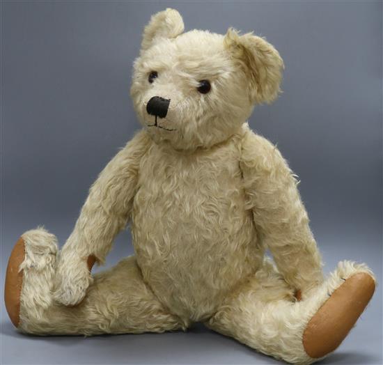 A 1930s Farnell teddy bear, Joshua, with white curly mohair, black glass eyes, remains of black stitched nose,